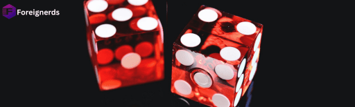 Two transparent red dice with white dots resting on a reflective black surface, accompanied by the Foreignerds logo in the top-left corner.